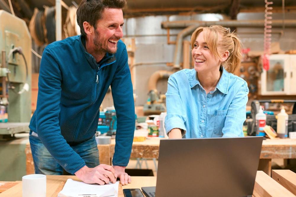 Two people in a woodwork workshop.