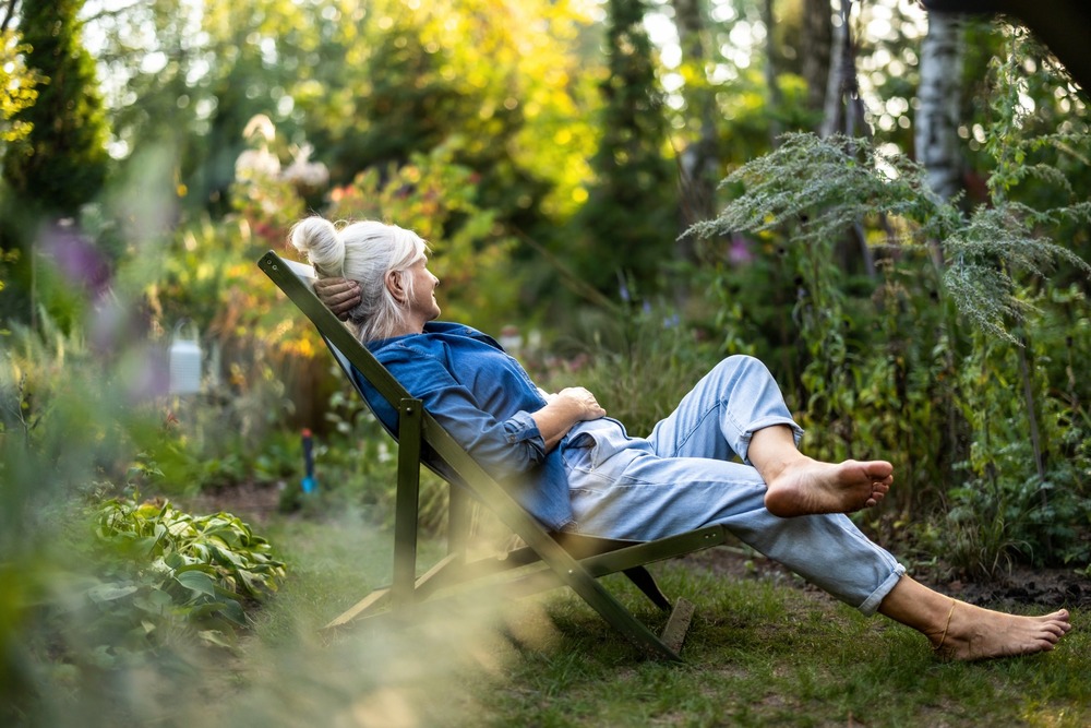A woman relaxing in a garden.