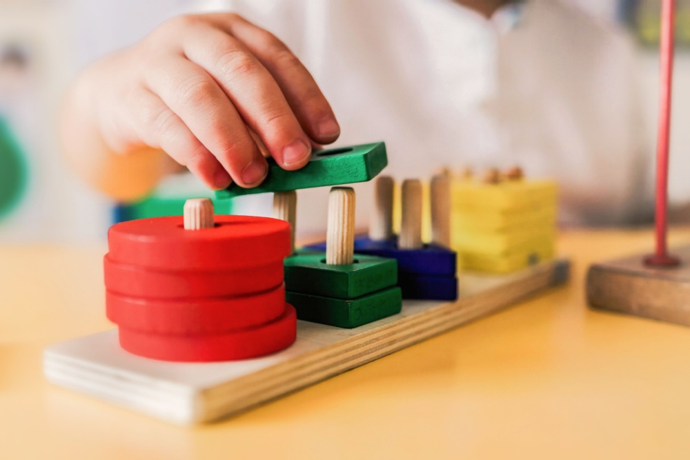 A child playing with wooden shapes.