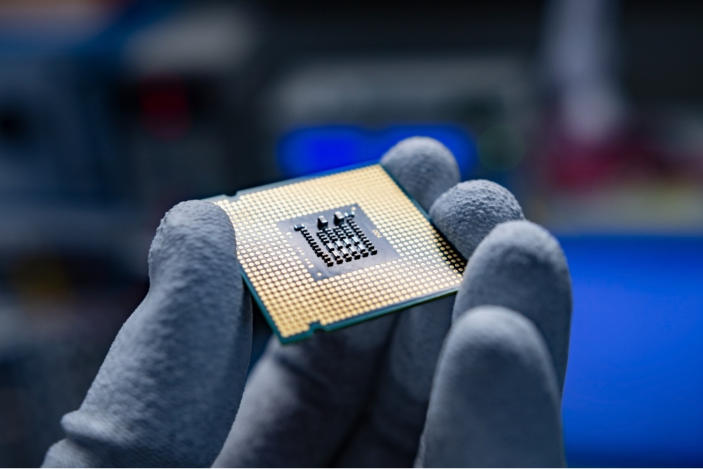 A hand holding a CPU.