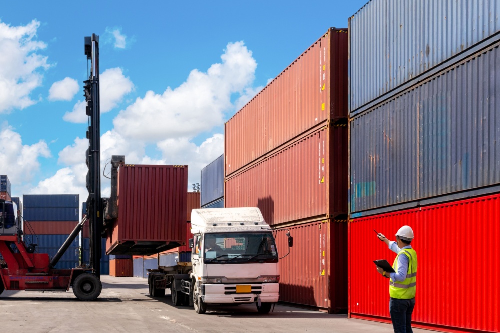 A foreman organising containers from a cargo ship.